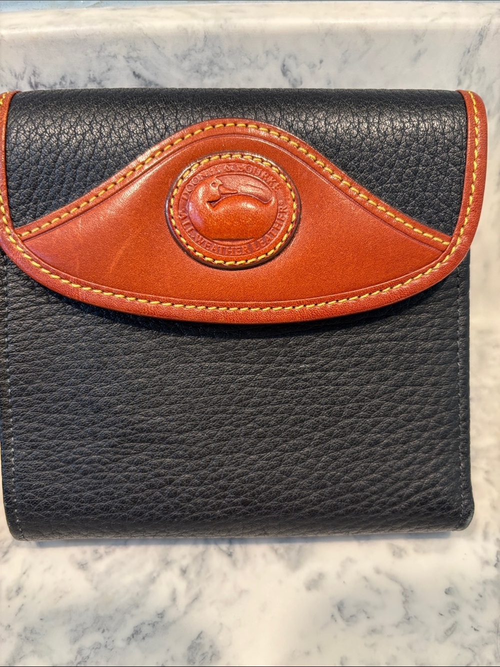 Dooney & Bourke Navy Leather Bifold Wallet with Brown Trim